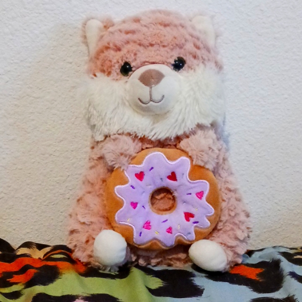 A hamster holding a donut